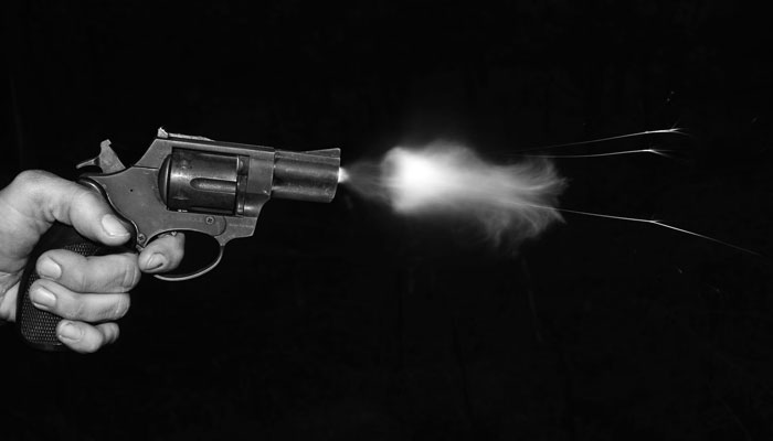 A person firing a bullet from a gun. — Unsplash/File