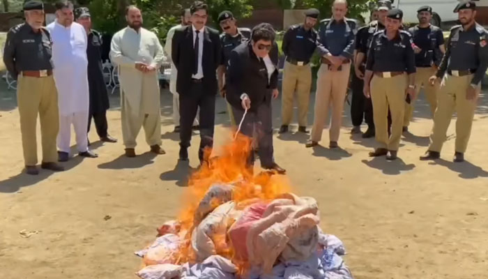 Police and other officials are ablaze seized drugs at the Police Lines in Bajaur on May 15, 2025. — Screengrab via Facebook@DistrictPoliceOfficerBajaur