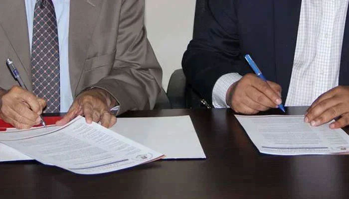 This representational image shows officials signs an agreement during a signing ceremony. — APPNA Website/File