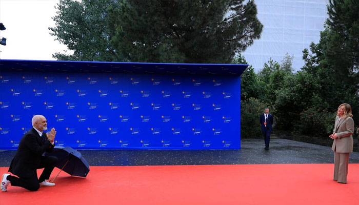 For Melonis arrival, Rama kneeling to the ground playfully for Giorgia Meloni. — AFP/File