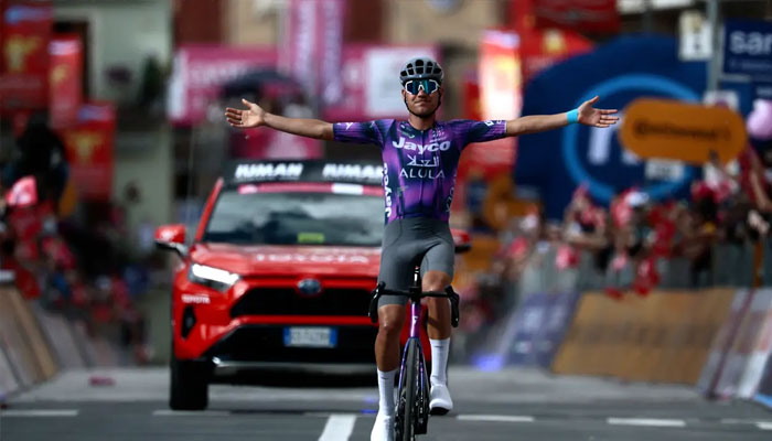 Team Jayco AlUlas Australian rider Luke Plapp celebrates victory as he crosses the finish line of the 8th stage of the 108th Giro dItalia cycling race of 197kms from Giulianova to Castelraimondo on 17 May 2025. —AFP