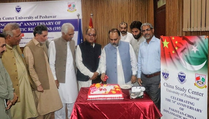 Provincial Minister for Social Welfare, Zakat, Ushar, Special Education, and Women’s Empowerment Syed Qasim Ali Shah (2nd right) cuts the 74th anniversary of the diplomatic relations between Pakistan and China at the University of Peshawar on May 16, 2025. — Facebook@UniversityOfPeshawarOfficialPage