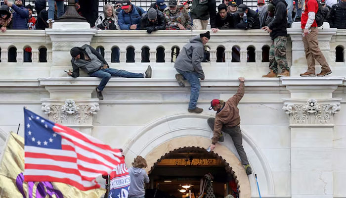 A mob of supporters of US President Donald Trump fight with members of law enforcement at a door they broke open as they storm the US Capitol Building in Washington, US, January 6, 2021. — Reuters