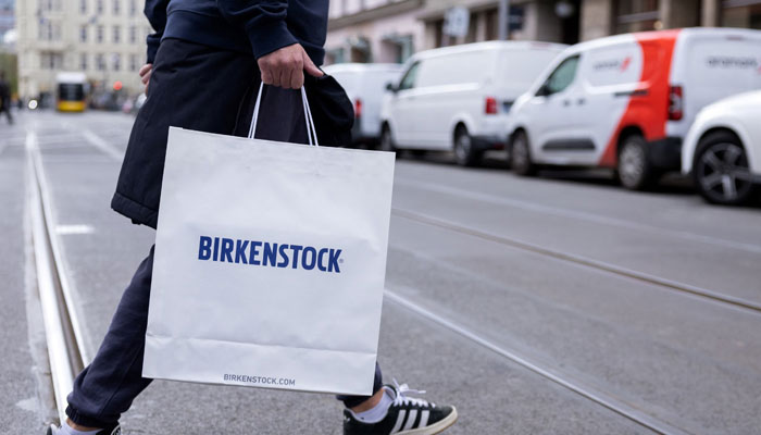 A person carries a Birkenstock branded shopping bag in Berlin, Germany, April 8, 2025. — Reuters