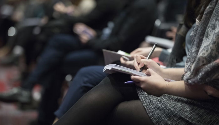 A representational image shows participants with a diary. — Unsplash/File