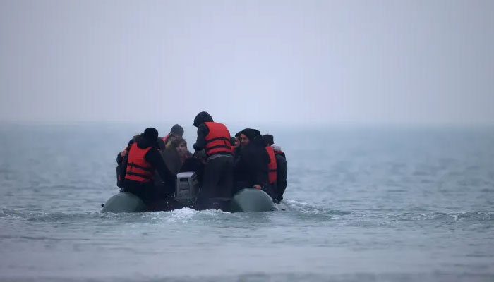 A group of people on an inflatable dinghy leave the coast of northern France to cross the English Channel, near Wimereux, France, November 24, 2021. — Reuters