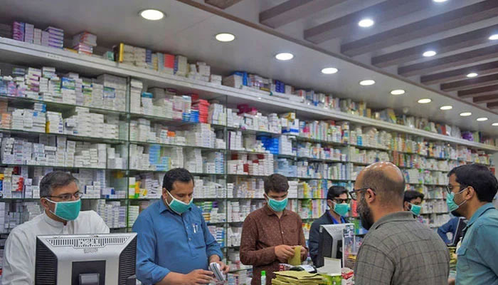 This representational image shows pharmacy employees attend to customers in Islamabad in this undated image. — AFP/File