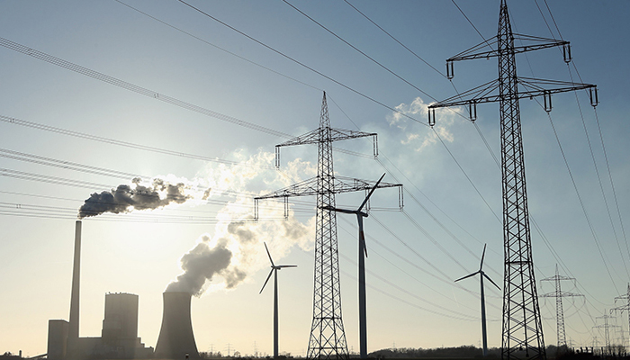 An electric power production company can be seen alongside heavy transmission lines. — AFP/File
