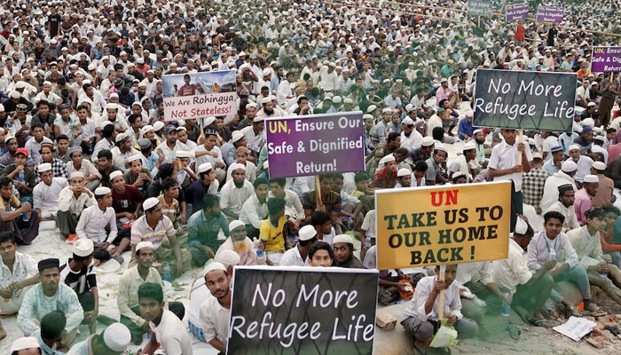 Rohingya refugees hold placards while attending a Ramadan Solidarity Iftar to have an Iftar meal with United Nations Secretary-General Antonio Guterres and Muhammad Yunus, Chief Adviser of Bangladesh Interim Government, at the Rohingya refugee camp in Coxs Bazar, Bangladesh, March 14, 2025.—Reuters