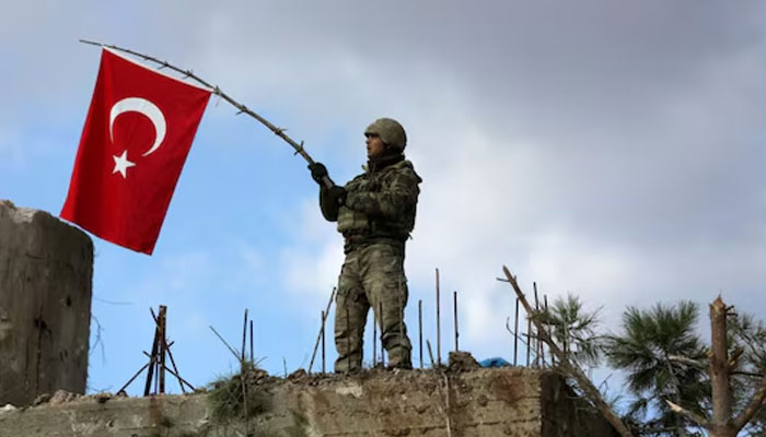 A Turkish soldier waves a Turkish flag.—Reuters/File