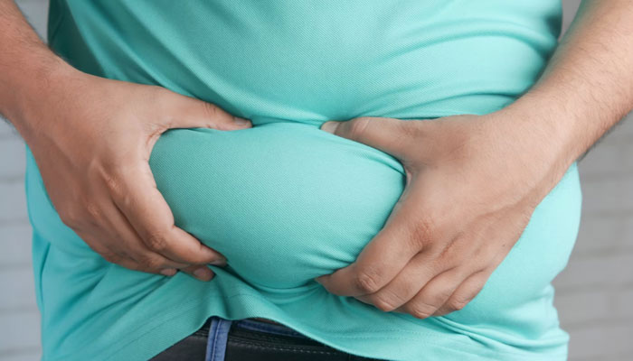 This representational image shows an obese person is holding his abdomen. — Unsplash/File