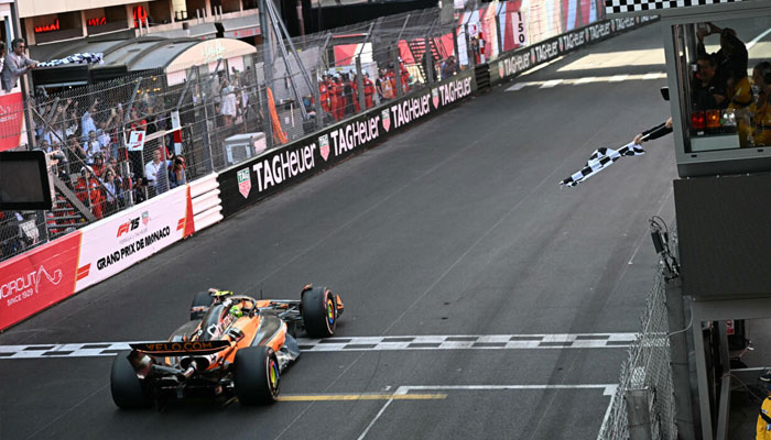 Lando Norris takes the chequered flag at Monaco to reignite his world title bid. —AFP/File