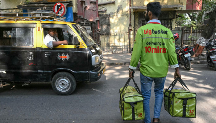 A delivery boy carrying parcels in Mumbai India. —AFP/File
