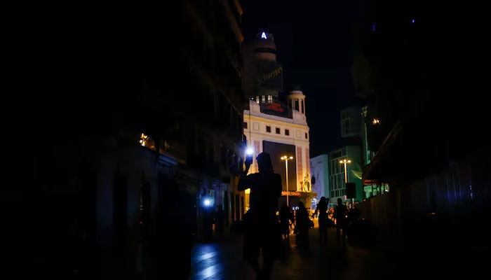 People use their mobile phones flashlights to walk in the dark during a nationwide power outage in Madrid, Spain, April 28, 2025. — Reuters