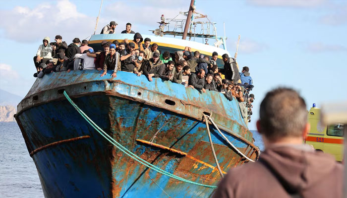 Migrants stand onboard a fishing boat at the port of Paleochora, following a rescue operation off the island of Crete, Greece, November 22, 2022.—Reuters