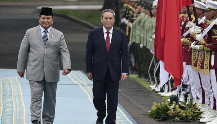 Indonesias President Prabowo Subianto (left) and Chinese Premier Li Qiang inspect a guard of honour during a welcoming ceremony in Jakarta. —AFP/File