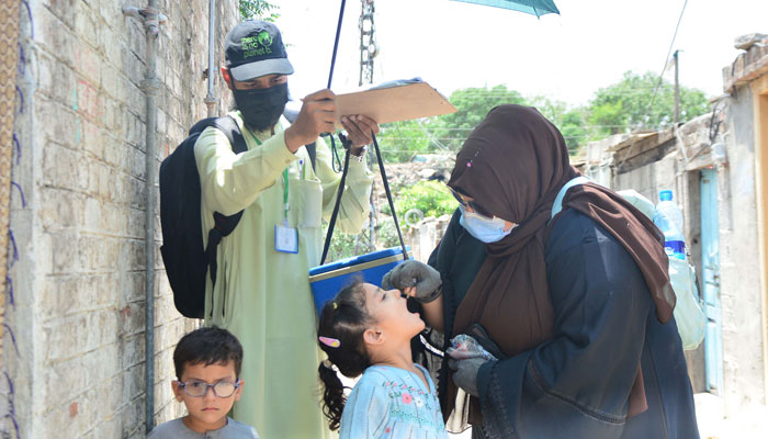A health worker administers polio drops to a child for vaccination on the first day of a nationwide week-long poliovirus eradication campaign in City on May 26, 2025. — Online