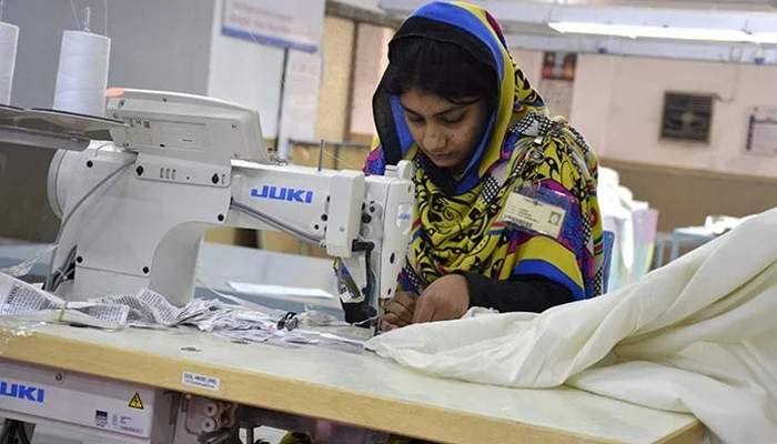 The representational image shows a female worker at a textile factory in Faisalabad.— AFP/File