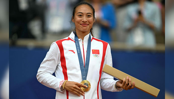 Chinas Gold medallist, Zheng Qinwen poses with her medal on the podium at the presentation ceremony for the womens singles tennis event on Court Philippe-Chatrier at the Roland-Garros Stadium during the Paris 2024 Olympic Games, in Paris on August 3, 2024. — AFP