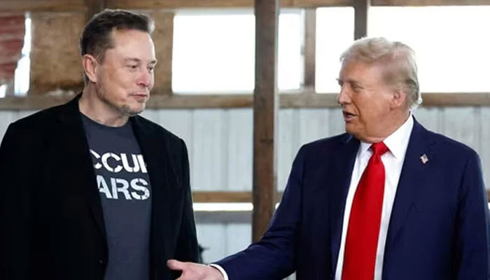The image shows Tesla CEO Elon Musk interacting with US president Donald Trump. — AFP/File