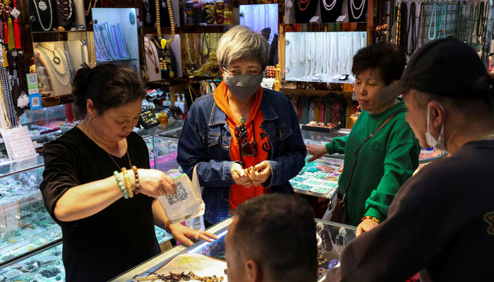 People shop at an accessory store in Fuyoumen Commercial Building in Shanghai, China April 16, 2025.—Reuters