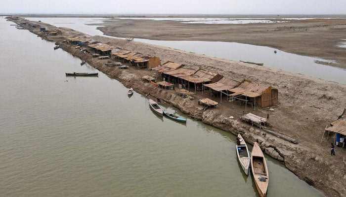 This aerial photograph taken on August 3, 2024, shows a settlement along the banks of a canal at Khan Muhammad Mallah village in Main Nara Valley, Dadu district of Sindh province. — AFP/File