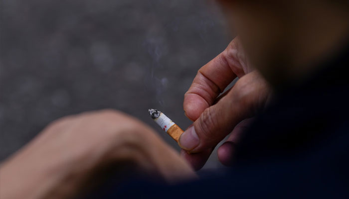 A man holds a cigarette in his hands in London, Britain April 11, 2023. — Reuters