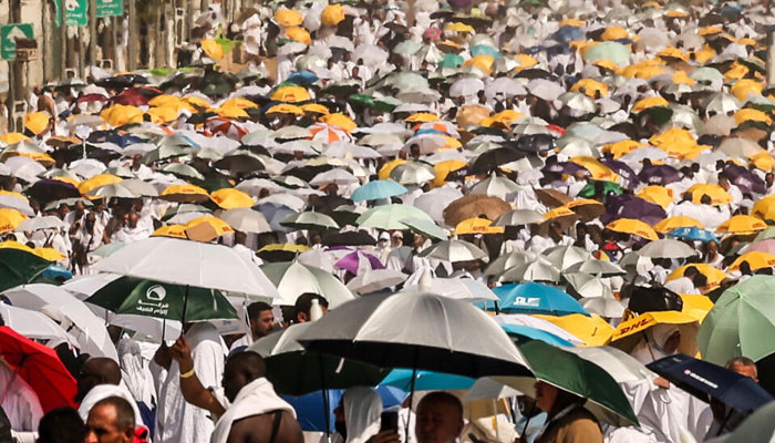 Muslim pilgrims use umbrellas to shade themselves from the sun. — AFP/File