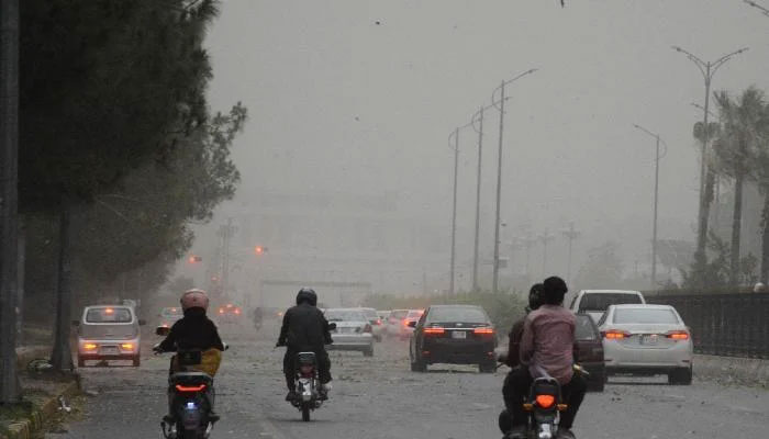 Commuters drive on a road during a dust storm in Islamabad after couple of hot days on May 27, 2025. — INP