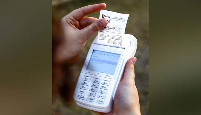 A representational image shows a person collecting an invoice. — Unsplash/File