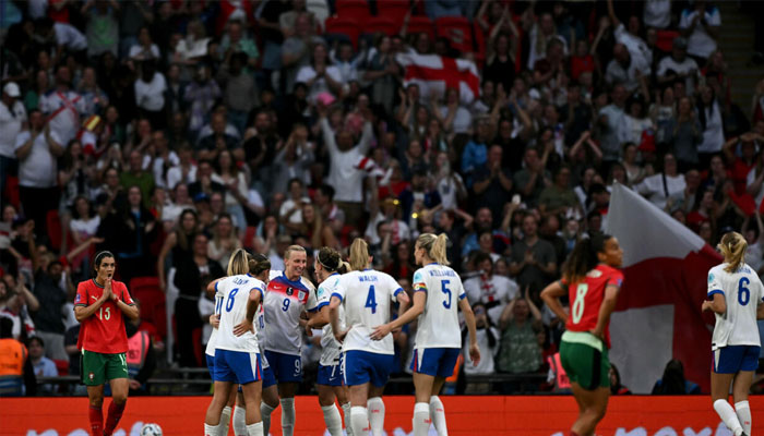 Aggie Beever-Jones (number 9) is mobbed by her England teammates after completing her Wembley hat-trick. —AFP/File