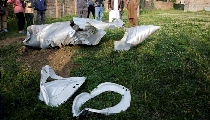 Metal debris lies on the ground in Wuyan in IIOJKs Pulwama district May 7, 2025. — Reuters