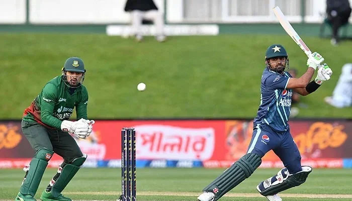 Pakistans Babar Azam plays a shot in front of Bangladeshs wicketkeeper Nurul Hasan during the Twenty20 tri-series cricket match between Pakistan and Bangladesh at Hagley Oval in Christchurch on October 13, 2022. — AFP