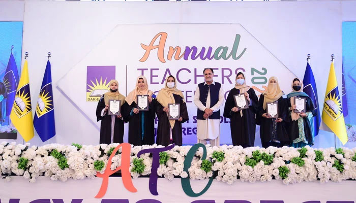Participants pose for a group photo at the annual teachers’ conference of Dar-e-Arqam Schools. — Facebook@DareArqamGujratRegion/File