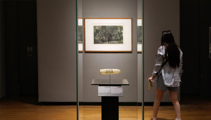 A women watching condom in museum in Amsterdam. —AFP/File