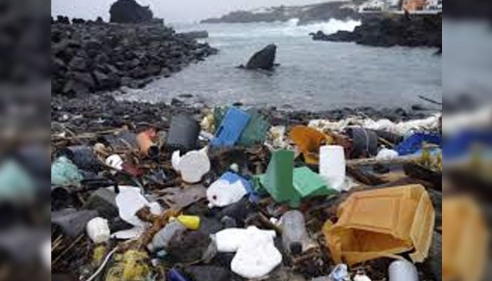 A heap of plastic waste can be seen on the shore. — APP/File