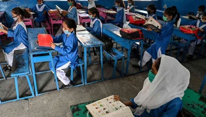 A representational image showing girls attending a class at a school in Punjab. — AFP/File