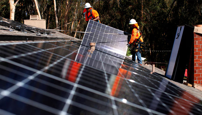 Solar installers from Baker Electric place solar panels on the roof of a residential home in Scripps Ranch, San Diego, California, US October 14, 2016. Picture taken October 14, 2016. — Reuters