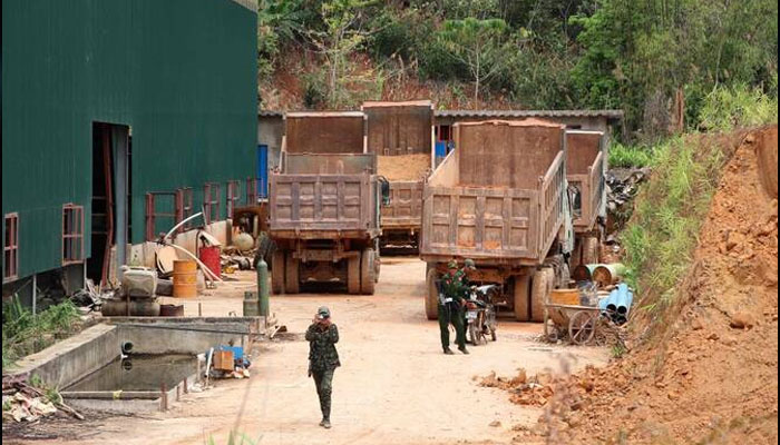 Members of the Kayan New Land Party standing guard near trucks at a China backed battery metal mine in Pekon township in Myanmars eastern Shan State. — AFP