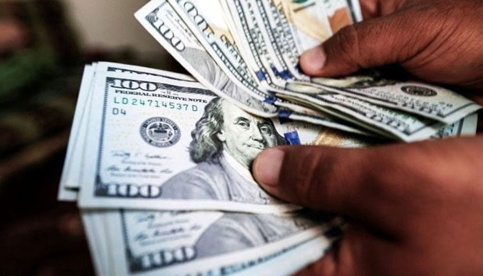 A man counting dollars. — AFP/File