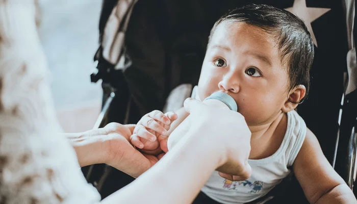 A representational image of an infant drinking baby milk. — Unsplash/File