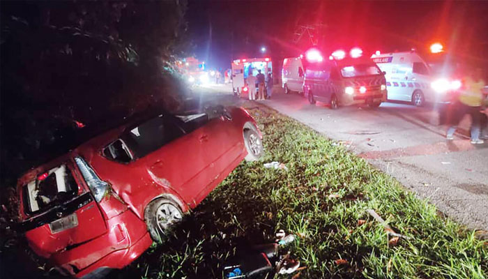 Crashed minivan can be seen beside road after accident. — AFP/File