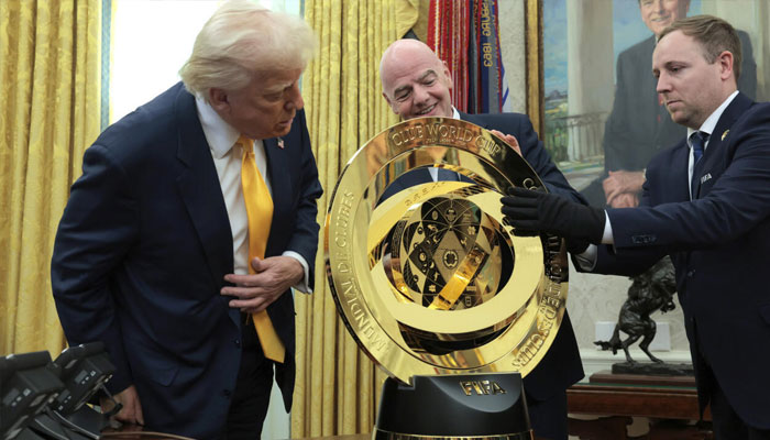 US President Donald Trump and FIFA president Gianni Infantino unveil the Club World Cup trophy in the Oval Office at the White House. —AFP/File