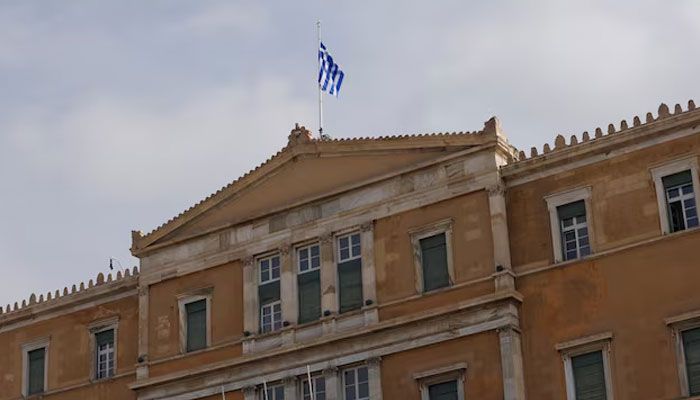 A Greek flag flutters atop the parliament building in Athens, Greece, March 1, 2023. —Reuters