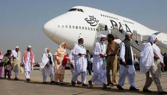 Pakistani pilgrims walk in line as they prepare to board Pakistan International Airlines special Hajj pilgrimage flight. — AFP/File