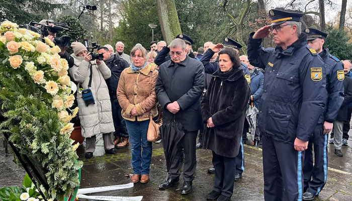 Police salutes in front of a wreath the day after two people, one a child, were killed in a knife attack, in Aschaffenburg, Germany, January 23, 2025.—Reuters
