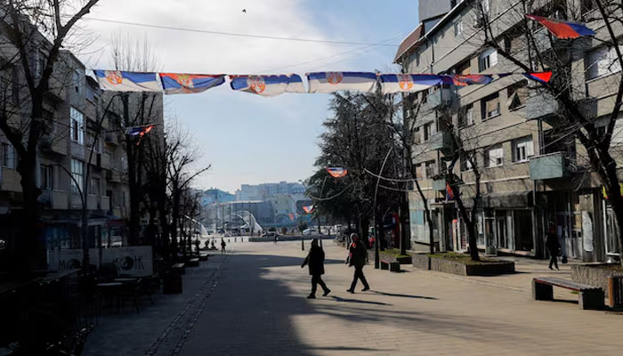 Pedestrians walk in Mitrovica, Kosovo, February 1, 2024.—Reuters