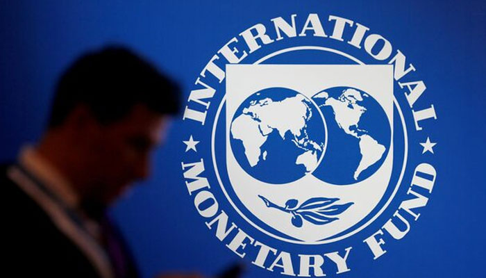 A participant stands near a logo of IMF at the International Monetary Fund. —Reuters/File