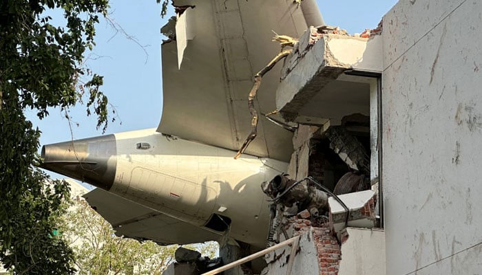 A tail of an Air India Boeing 787 Dreamliner plane that crashed is seen stuck on a building after the incident in Ahmedabad, India, June 12, 2025. — Reuters