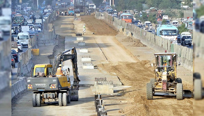 Heavy machinery being used during the development work at University Road in Karachi on September 25, 2024. — APP